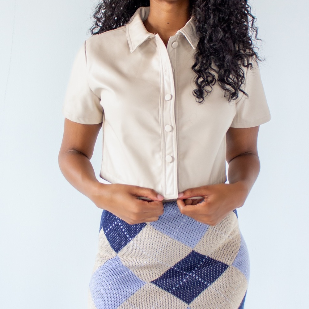 In nude, short sleeve top, button down.